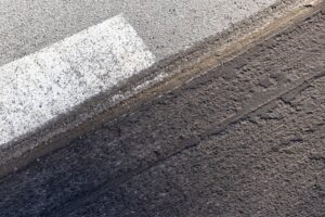 City street asphalt under renovation with milled tarmac surface