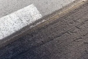 Can You Put Asphalt Over Concrete? What You Need to Know - Sipes Asphalt & Concrete City street asphalt under renovation with milled tarmac surface